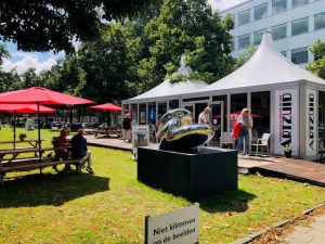 a group of lawn chairs sitting on top of a grass covered field