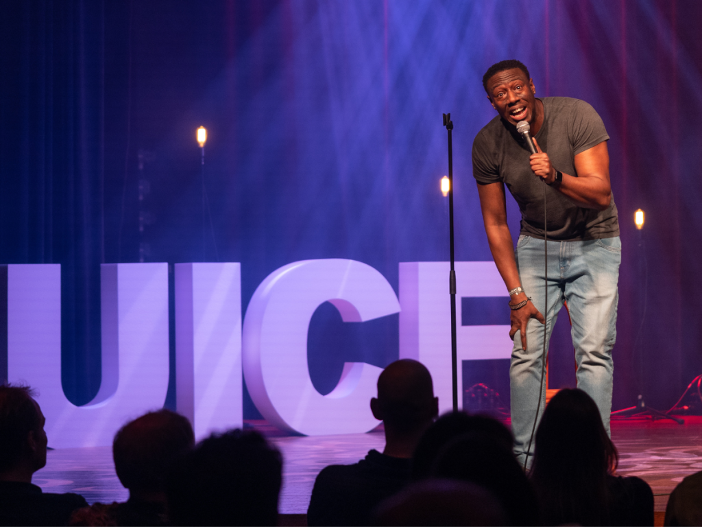 Nathan Caton standing on a stage in front of a crowd