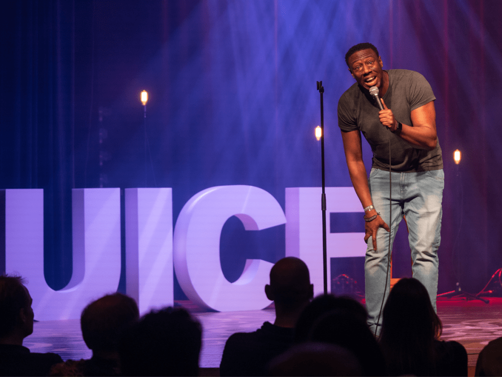 Nathan Caton standing on a stage in front of a crowd