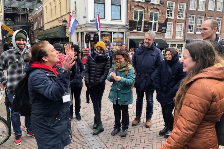 a group of people standing in front of a building laughing