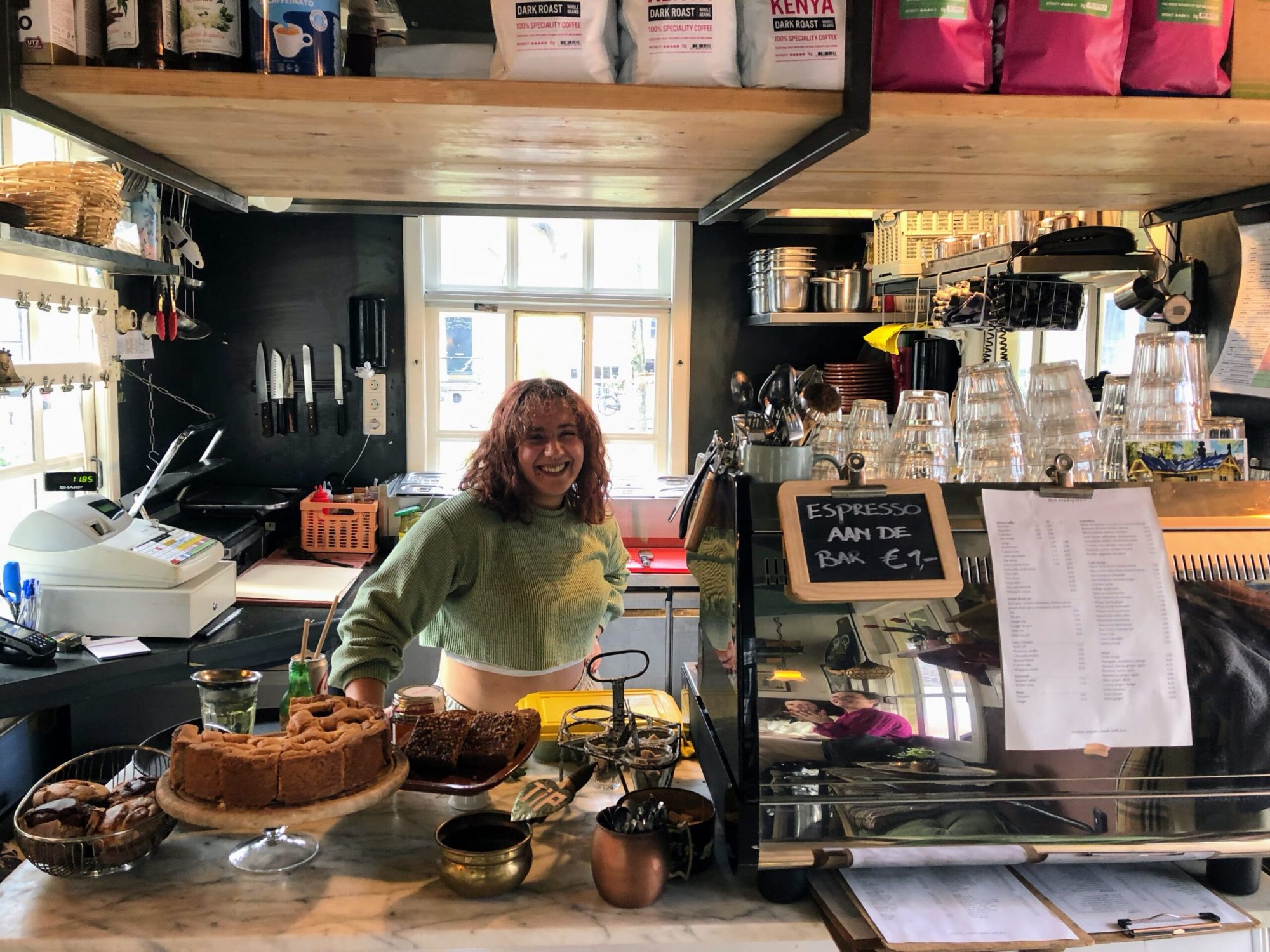 a person preparing food at a cute coffee place Amsterdam