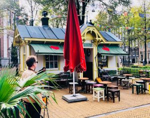 a group of people in front of a coffee place at cute coffee places Amsterdam