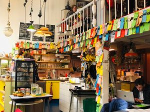 a group of people in a store at cute coffee places Amsterdam